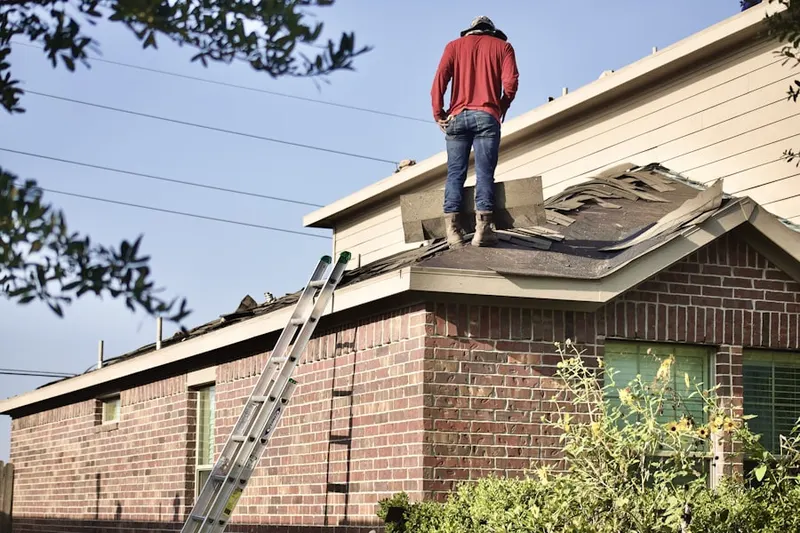 Professional roofer working on a residential roof in Brownstown